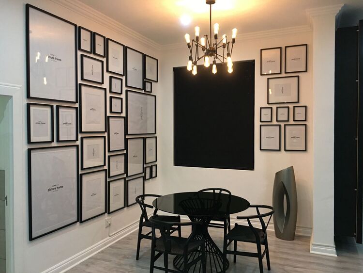 Handyman: Dining room table with chairs and a beautifully decorated wall.